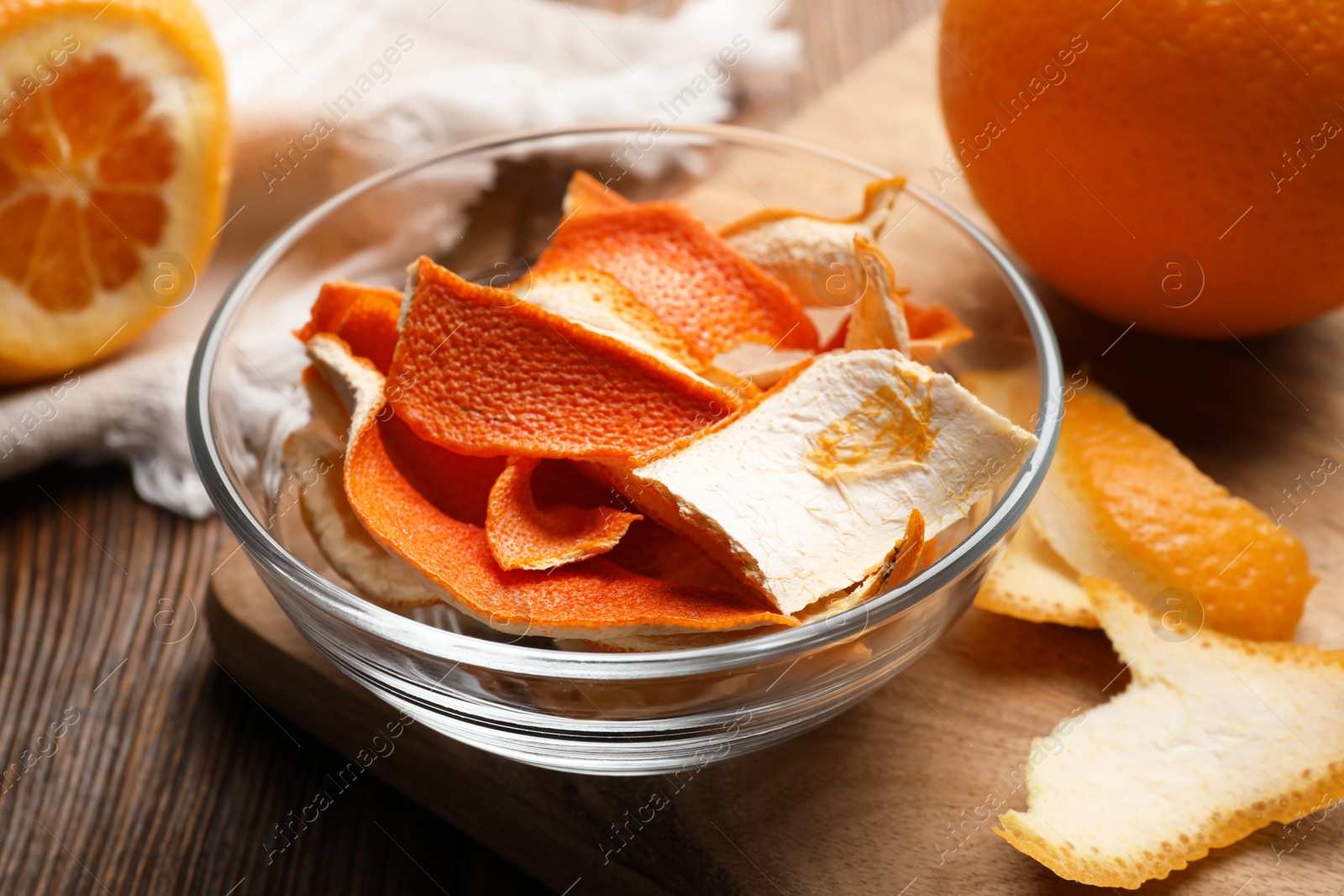 Photo of Dry orange peels on wooden table, closeup