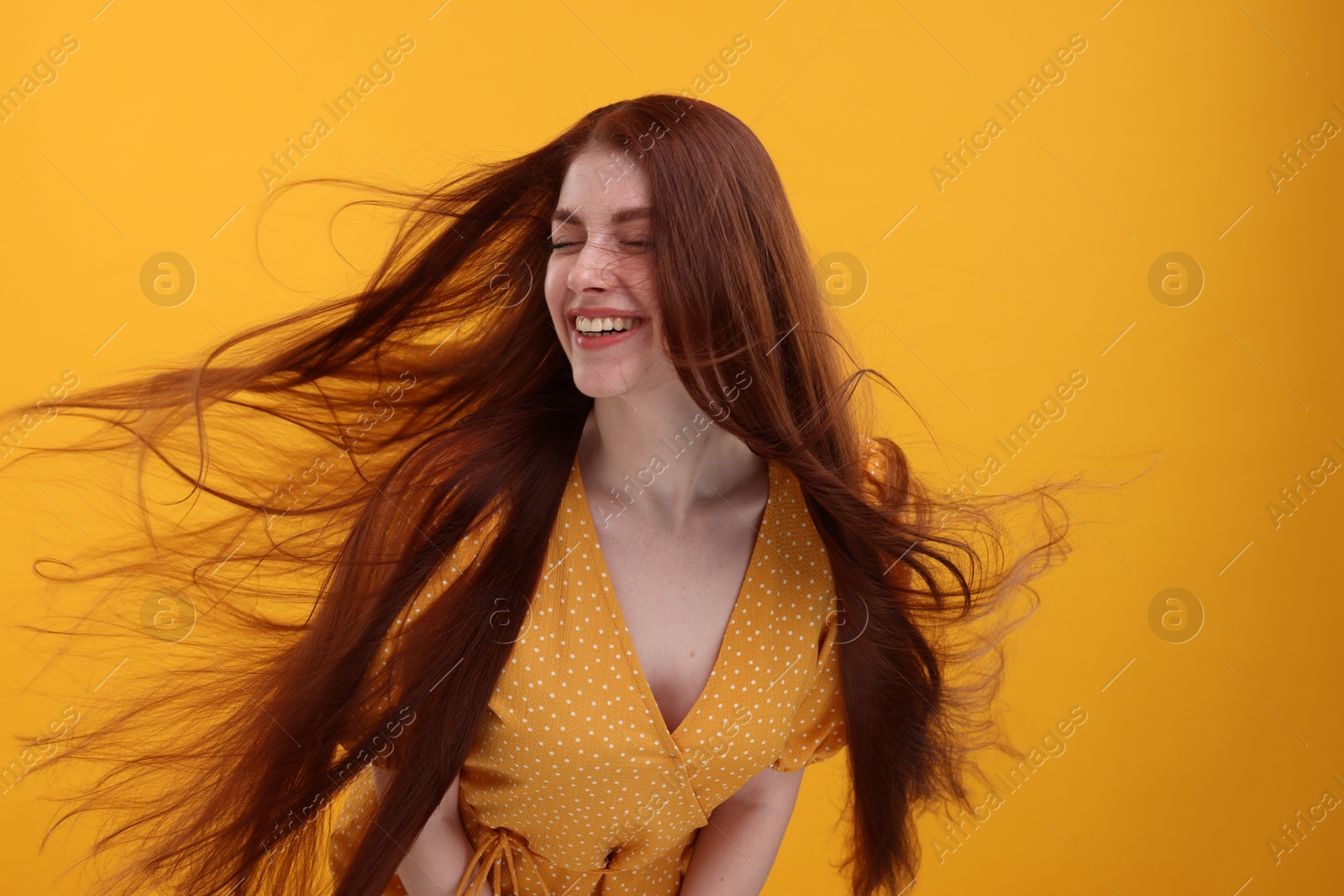 Photo of Portrait of smiling woman on yellow background