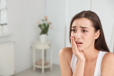 Photo of Young woman with eyelash loss problem indoors