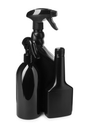 Photo of Black plastic spray bottles on white background