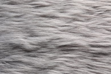 Texture of grey faux fur as background, top view