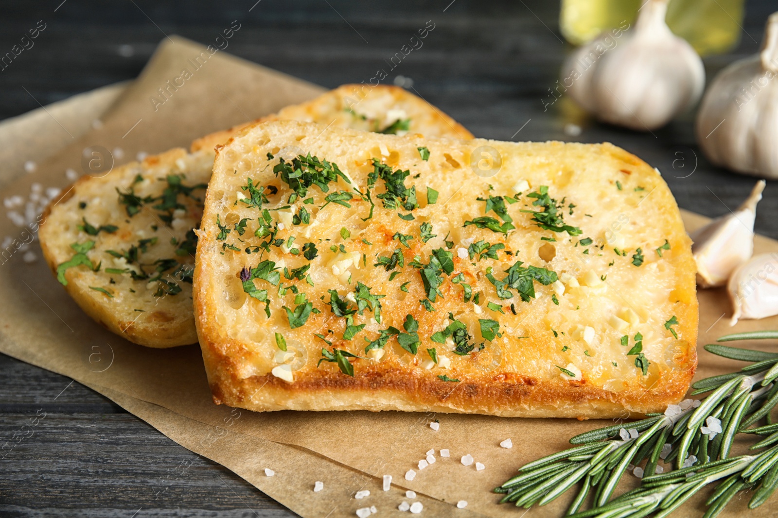 Photo of Tasty garlic bread with herbs on table