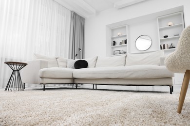 Photo of Fluffy carpet and stylish furniture on floor indoors, low angle view