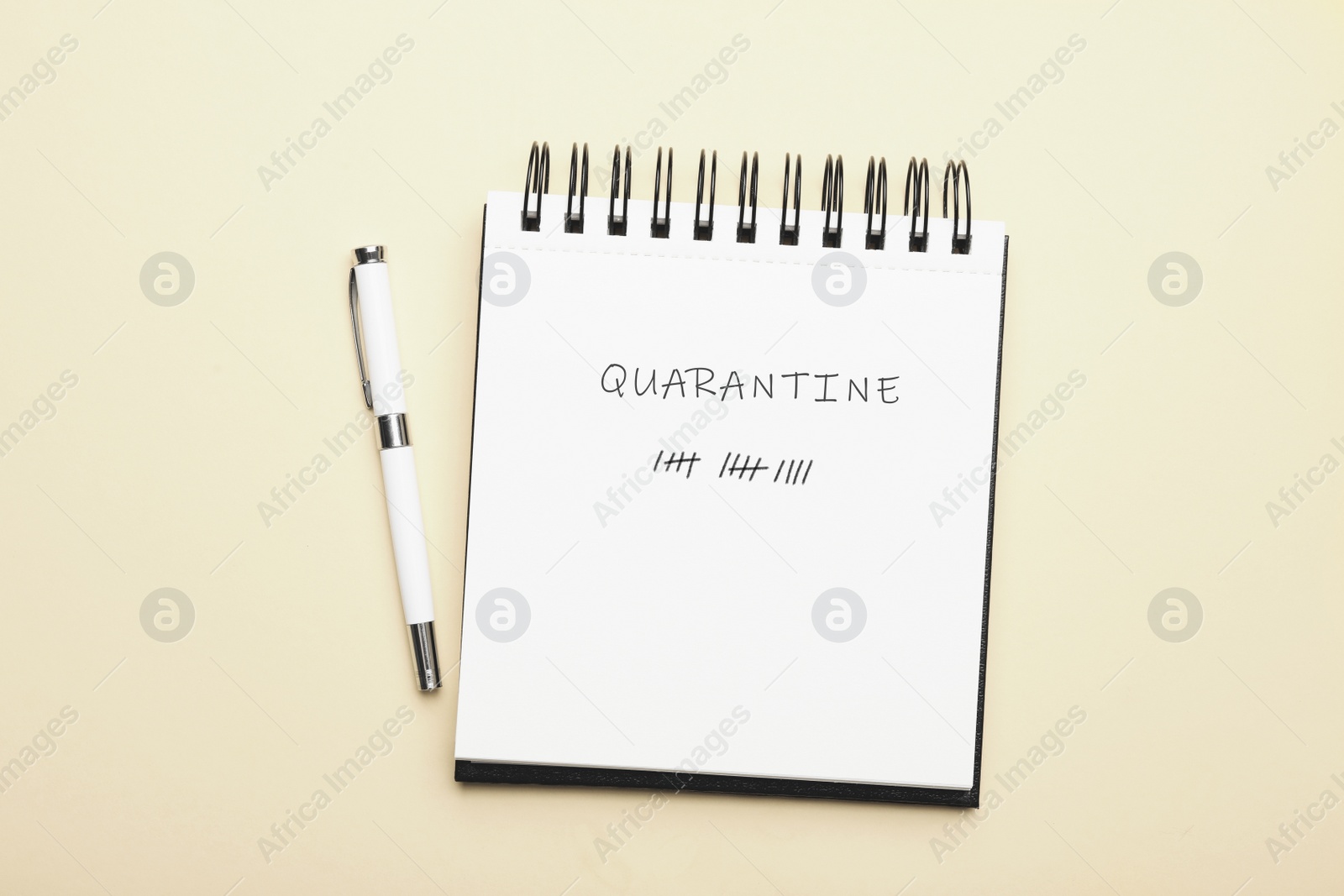 Image of Open notebook and pen on light background, top view. Counting days of quarantine during coronavirus outbreak