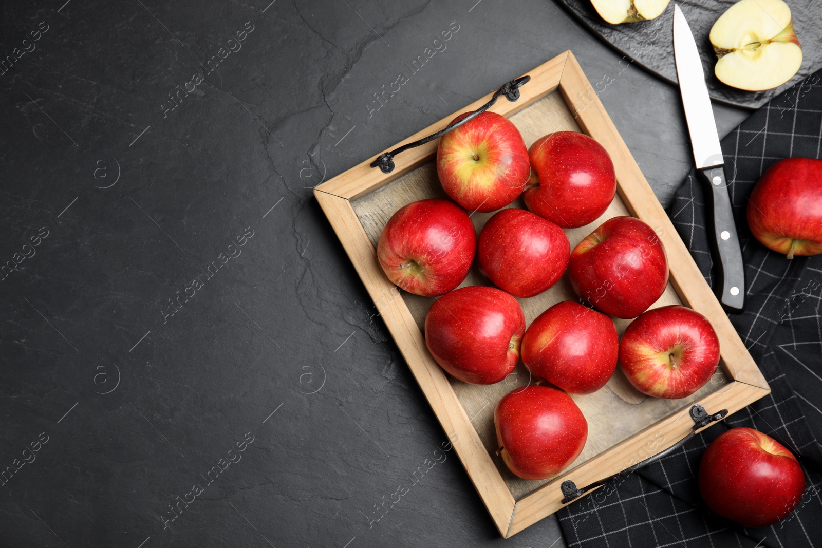 Photo of Fresh ripe red apples on black table, flat lay. Space for text