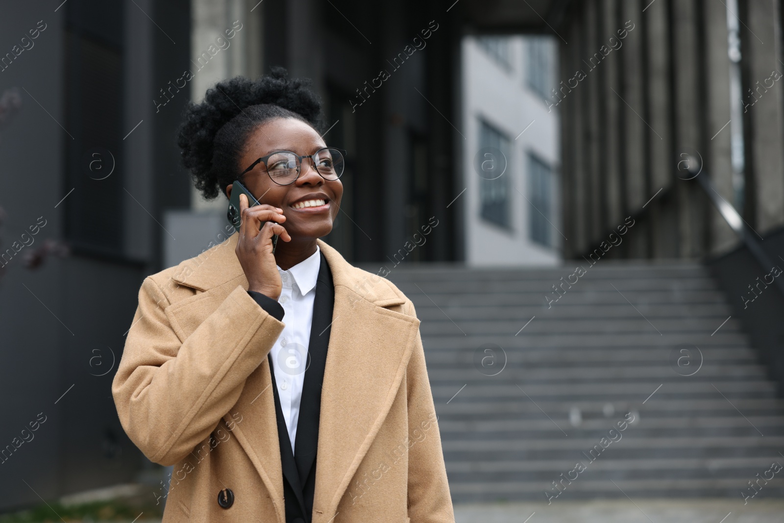 Photo of Happy woman talking on smartphone outdoors, space for text. Lawyer, businesswoman, accountant or manager