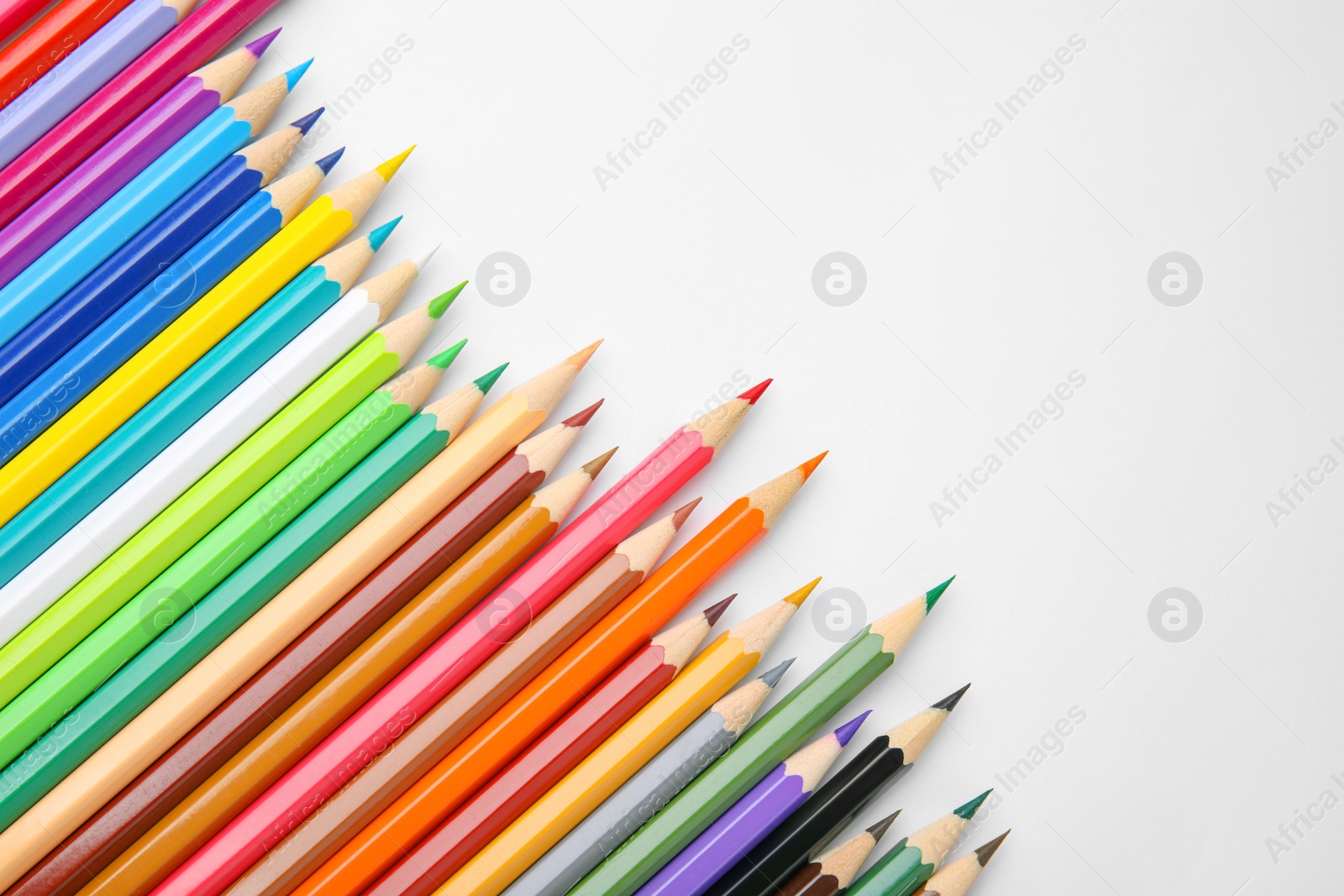 Photo of Many colorful wooden pencils on white background, flat lay. Space for text