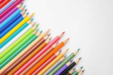 Photo of Many colorful wooden pencils on white background, flat lay. Space for text
