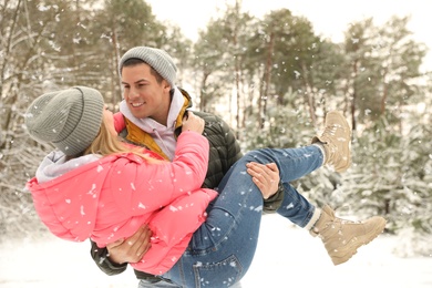 Photo of Beautiful happy couple in snowy forest on winter day