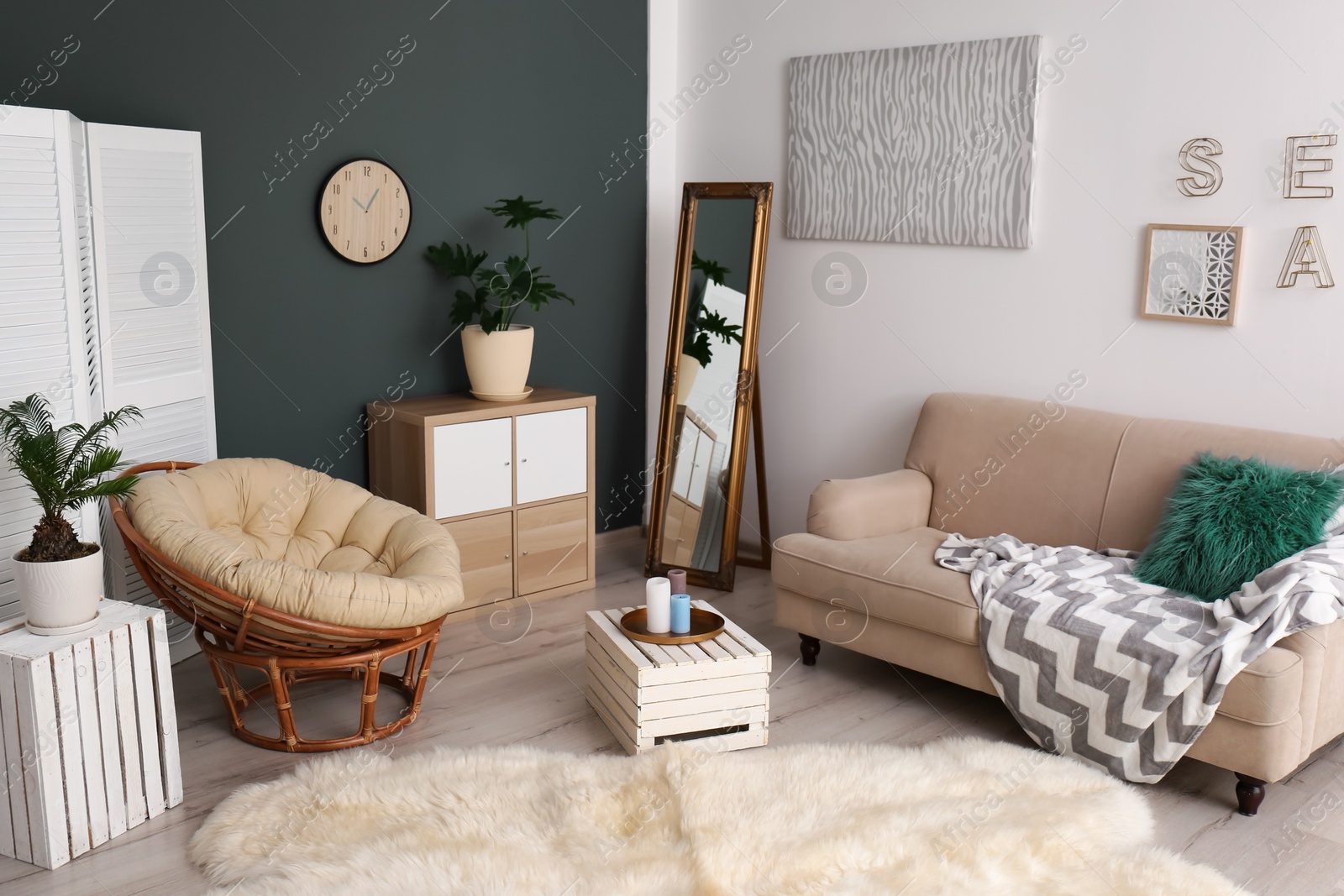 Photo of Tropical plants with green leaves and comfortable furniture in room interior