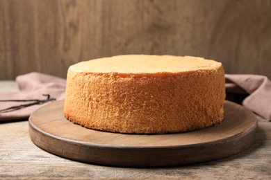 Photo of Delicious fresh homemade cake on wooden table