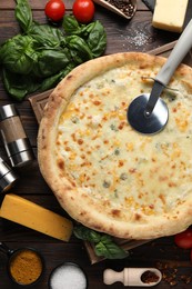 Photo of Flat lay composition with delicious cheese pizza and ingredients on wooden table