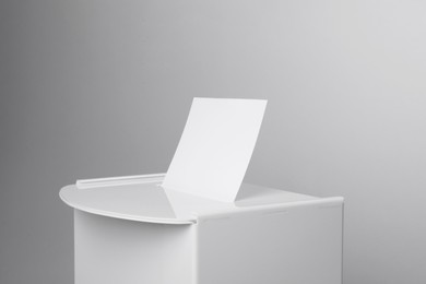 Photo of Ballot box with vote on light grey background, closeup. Election time