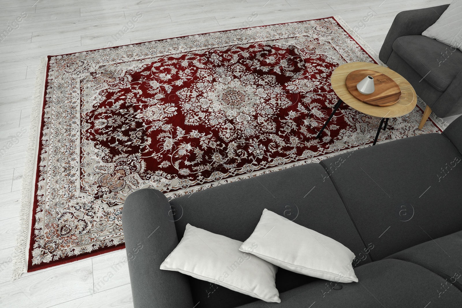 Photo of Cozy room interior with stylish furniture and soft carpet with beautiful pattern, view from above