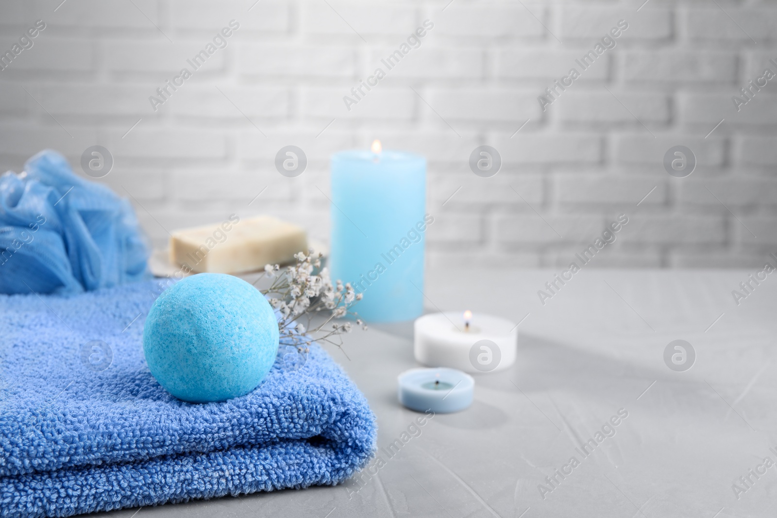 Photo of Beautiful composition with aromatic bath bomb on grey table, space for text