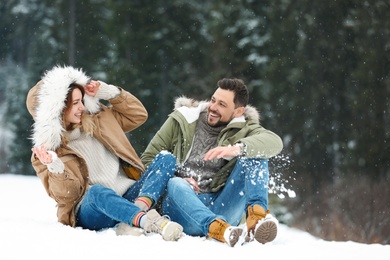 Photo of Couple spending time outdoors on snowy day. Winter vacation