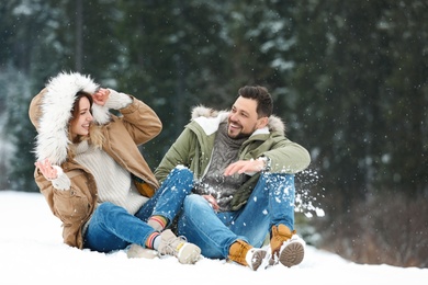 Couple spending time outdoors on snowy day. Winter vacation