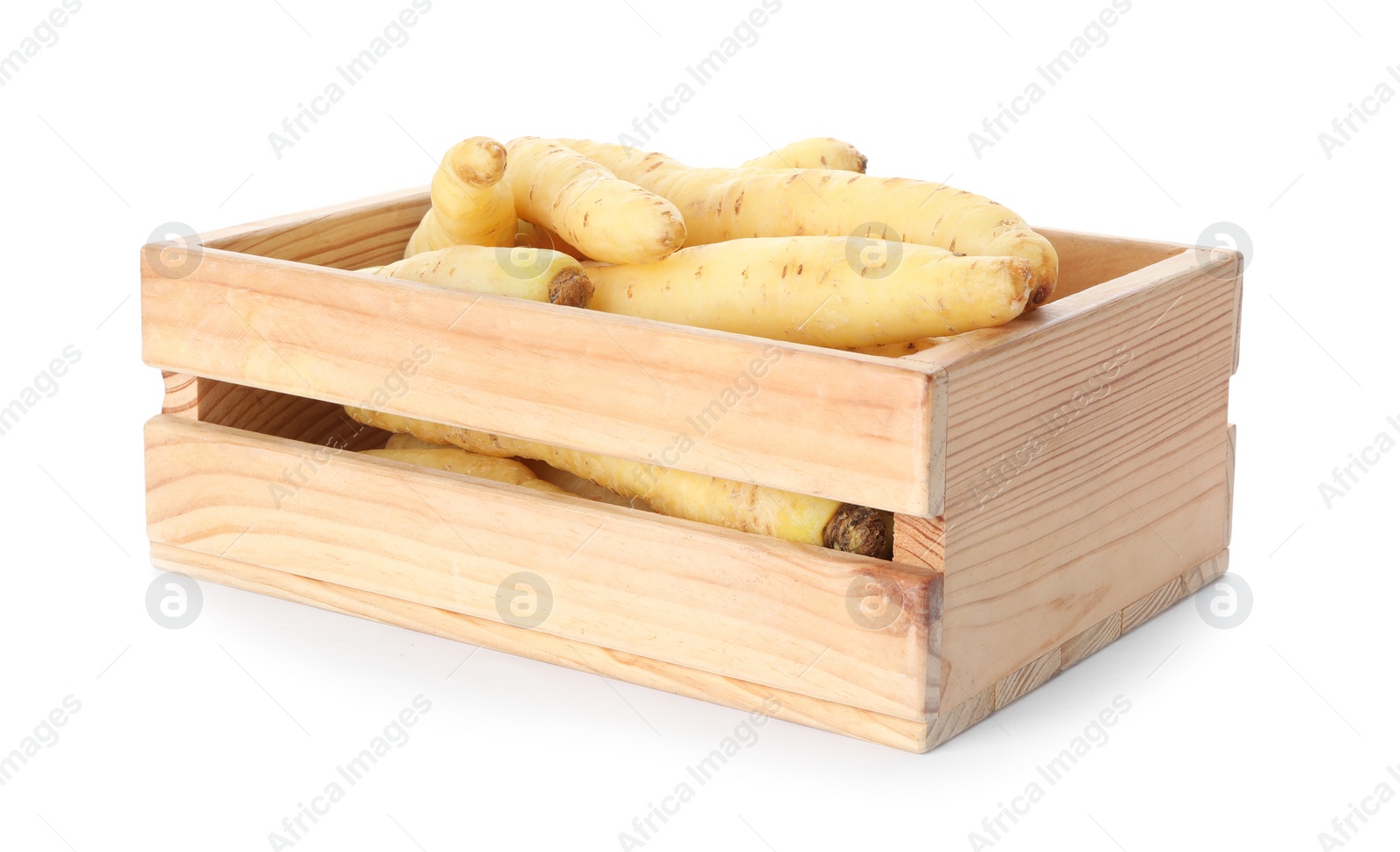 Photo of Fresh raw carrots in wooden crate isolated on white