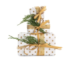 Christmas gift boxes decorated with fir branches on white background