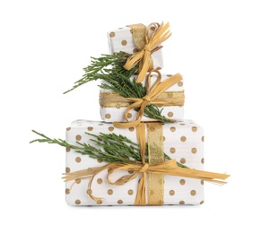 Photo of Christmas gift boxes decorated with fir branches on white background