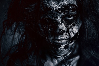 Scary zombie on dark background, black and white effect. Halloween monster