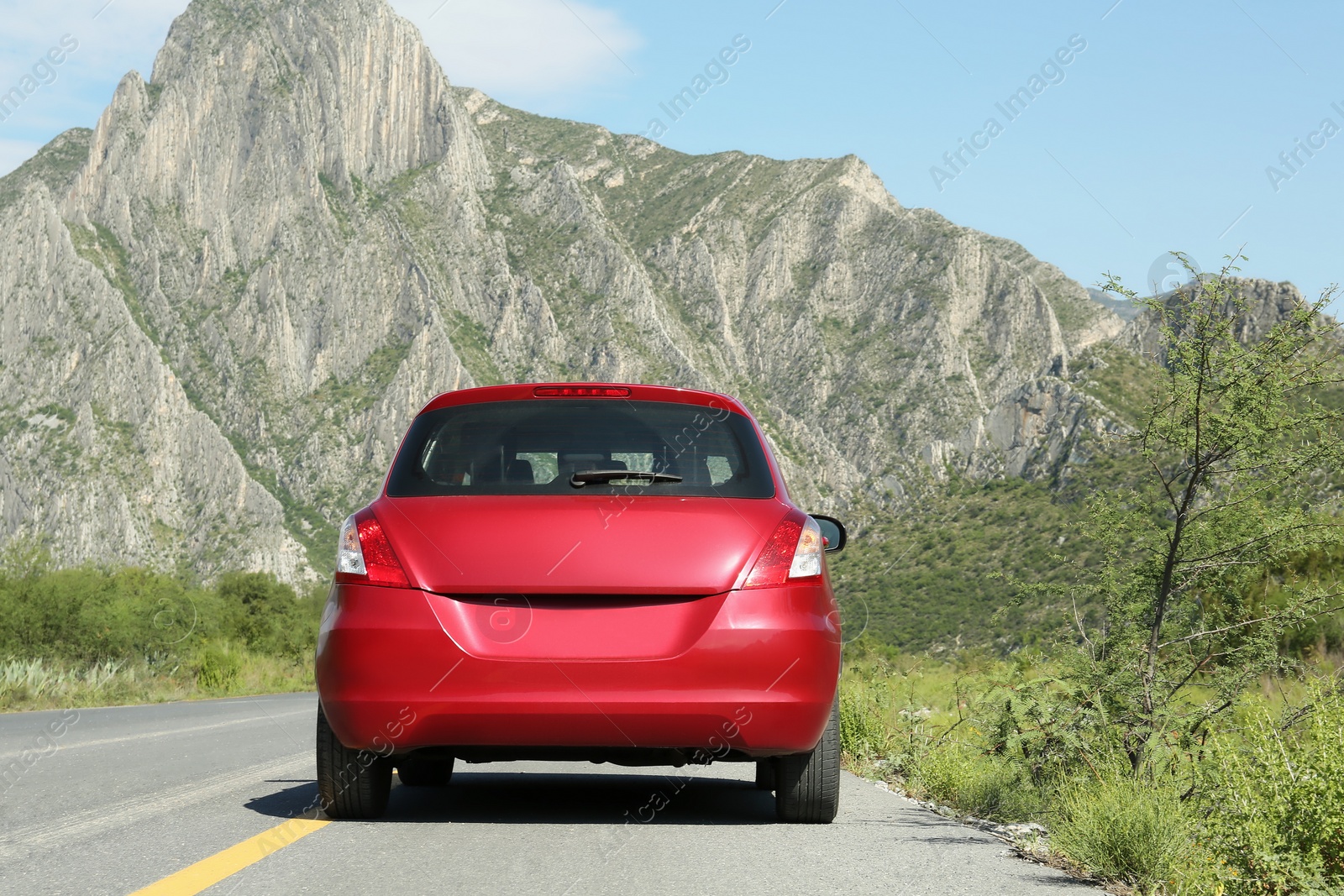 Photo of Beautiful view of car on asphalt highway in mountains. Road trip