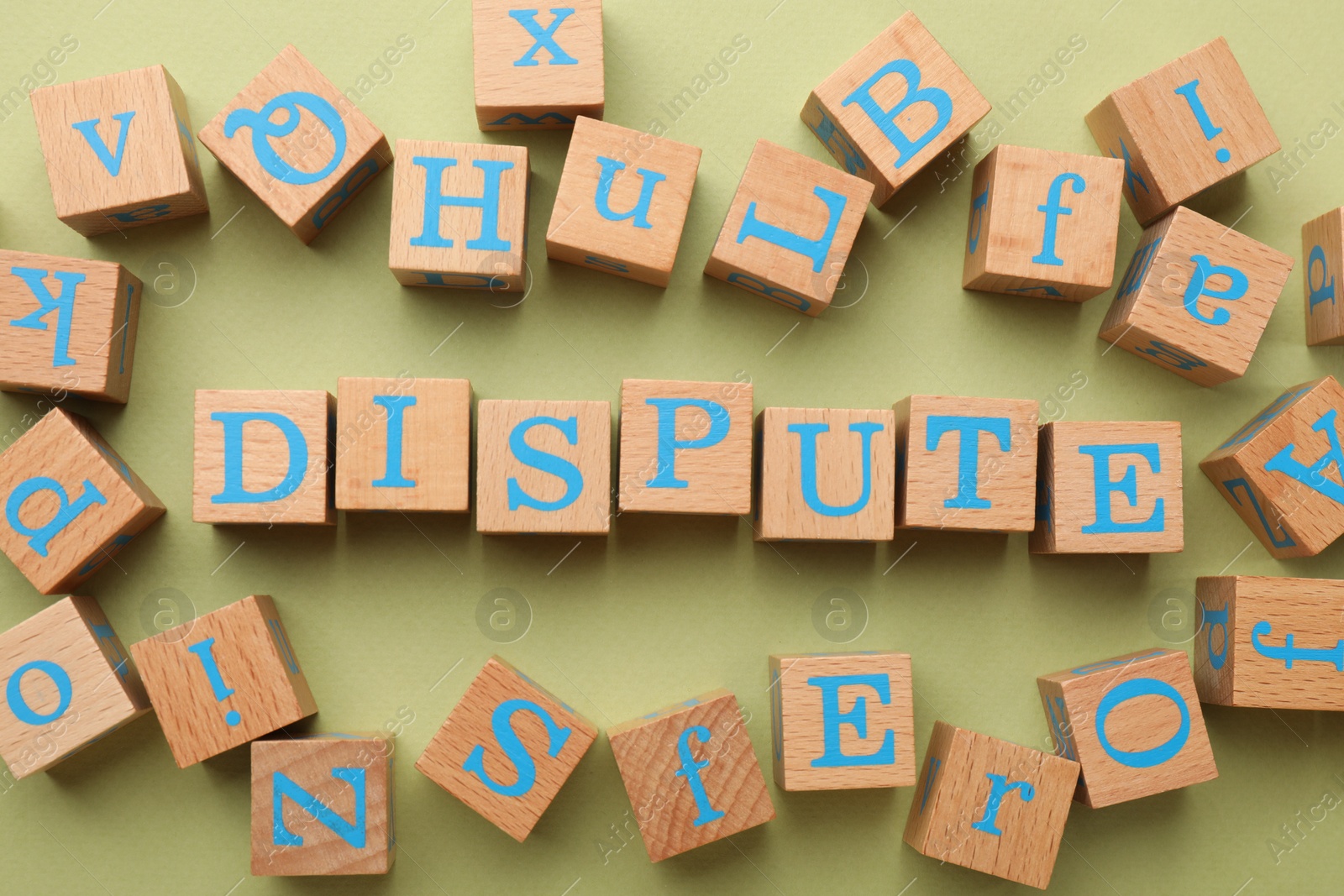 Photo of Cubes with word Dispute on light green background, flat lay