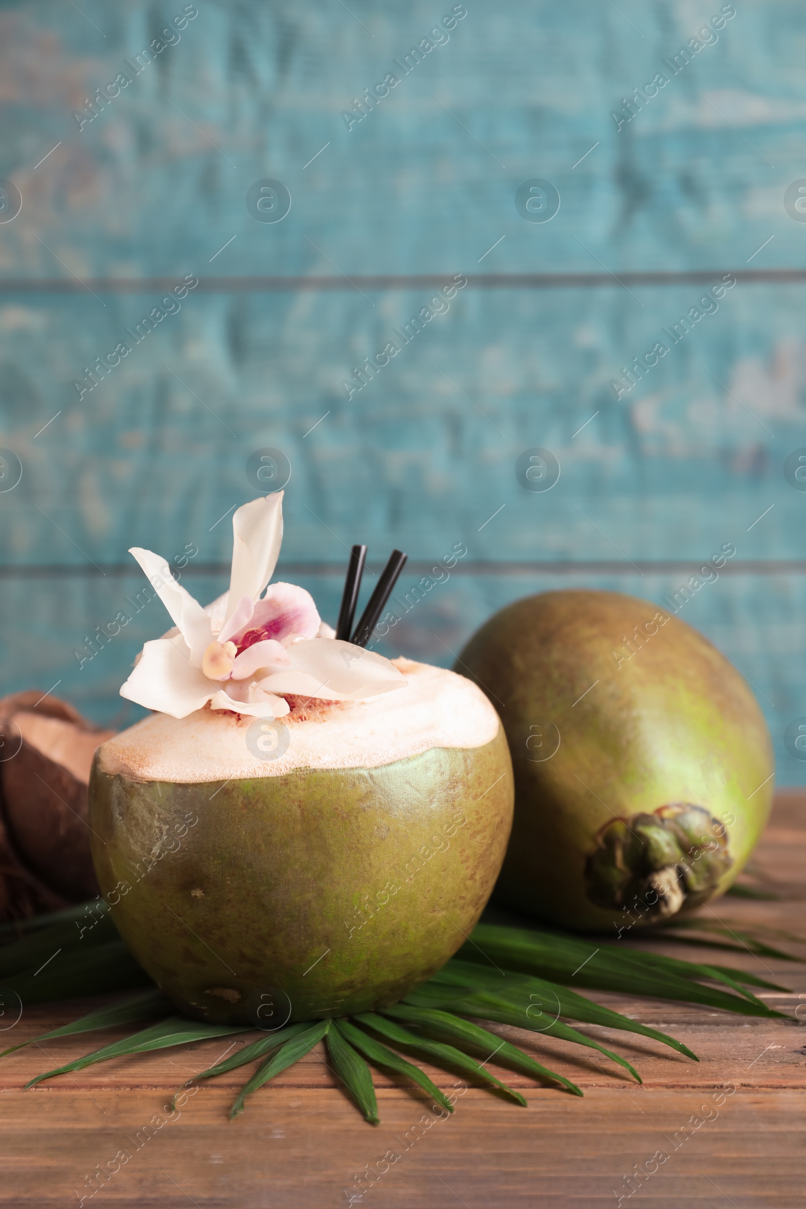 Photo of Fresh green coconuts on wooden table