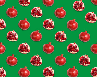 Image of Pattern of whole and halved pomegranates on green background
