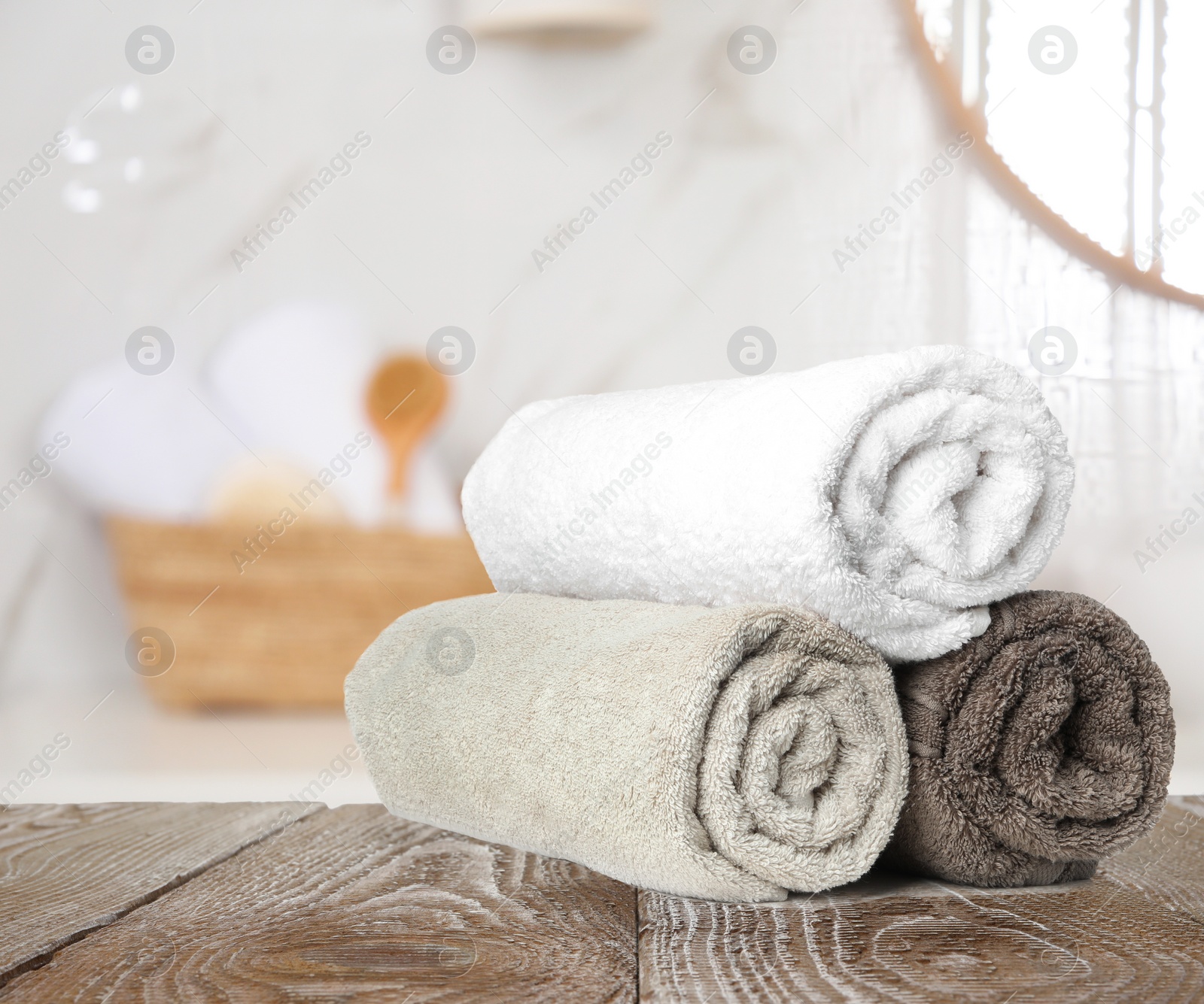 Image of Fresh towels on wooden table in bathroom