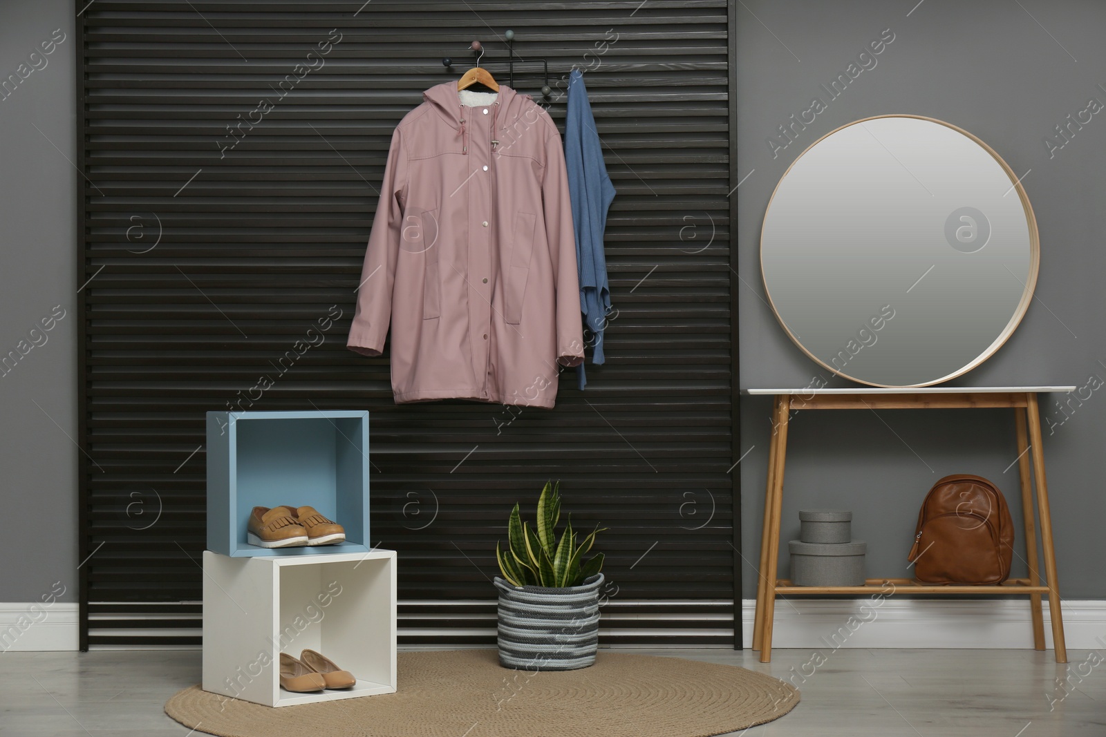 Photo of Hallway interior with stylish furniture, clothes and accessories