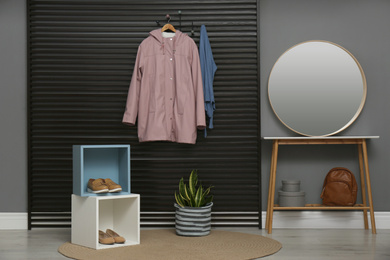 Hallway interior with stylish furniture, clothes and accessories