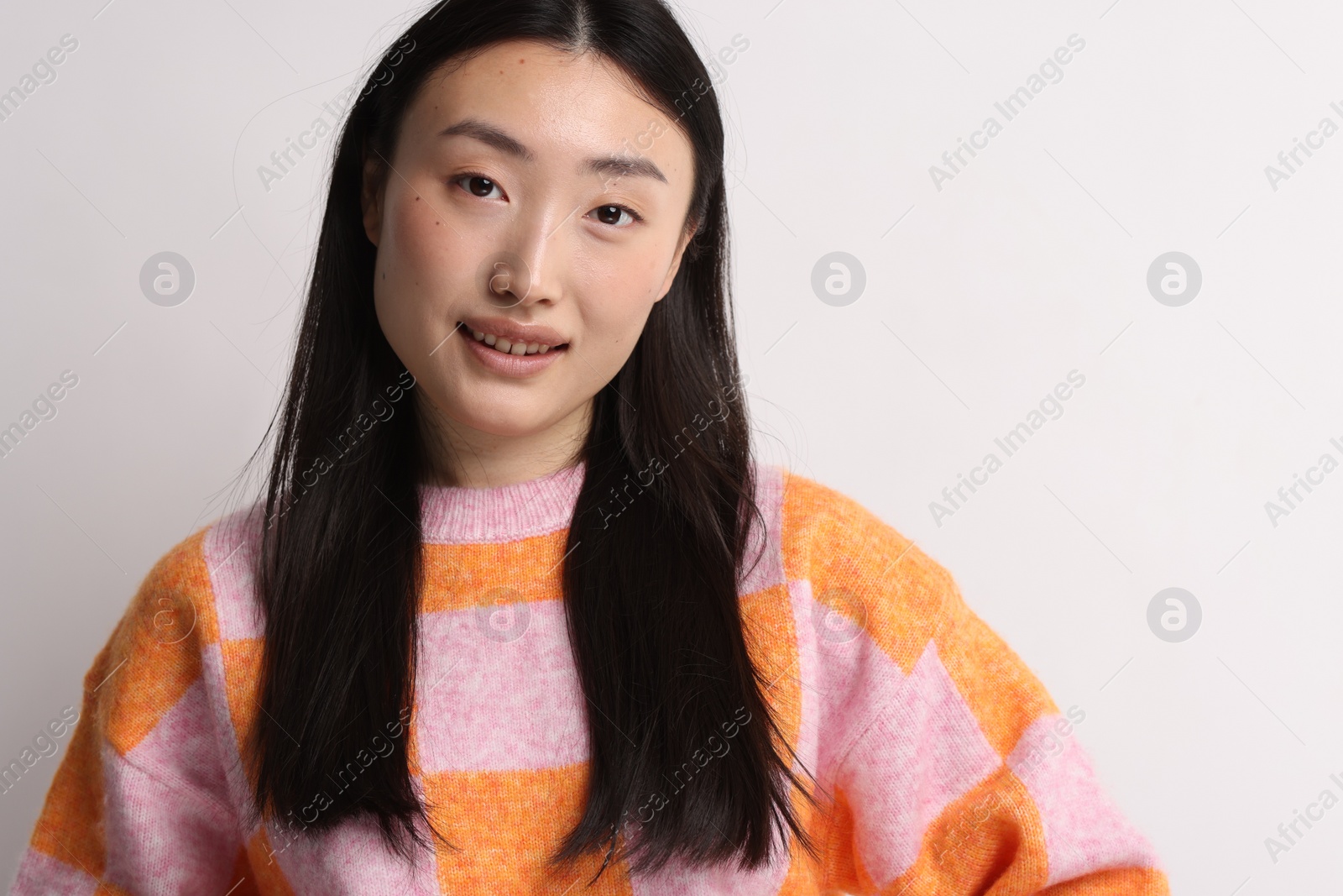 Photo of Portrait of smiling woman on light background