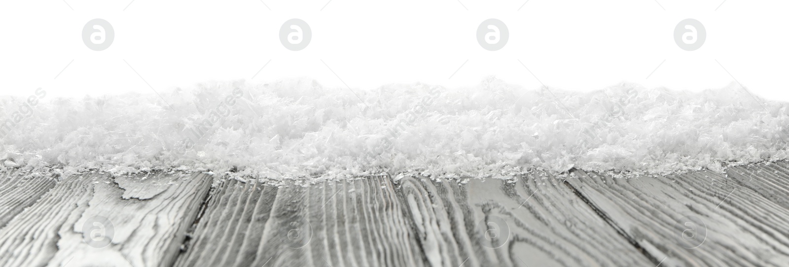 Photo of Snow on grey wooden surface against white background. Christmas season