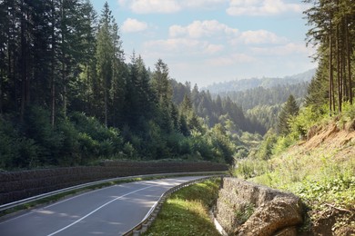 Photo of Picturesque view of empty asphalt road near forest