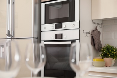 Photo of Modern combination oven with microwave in light kitchen