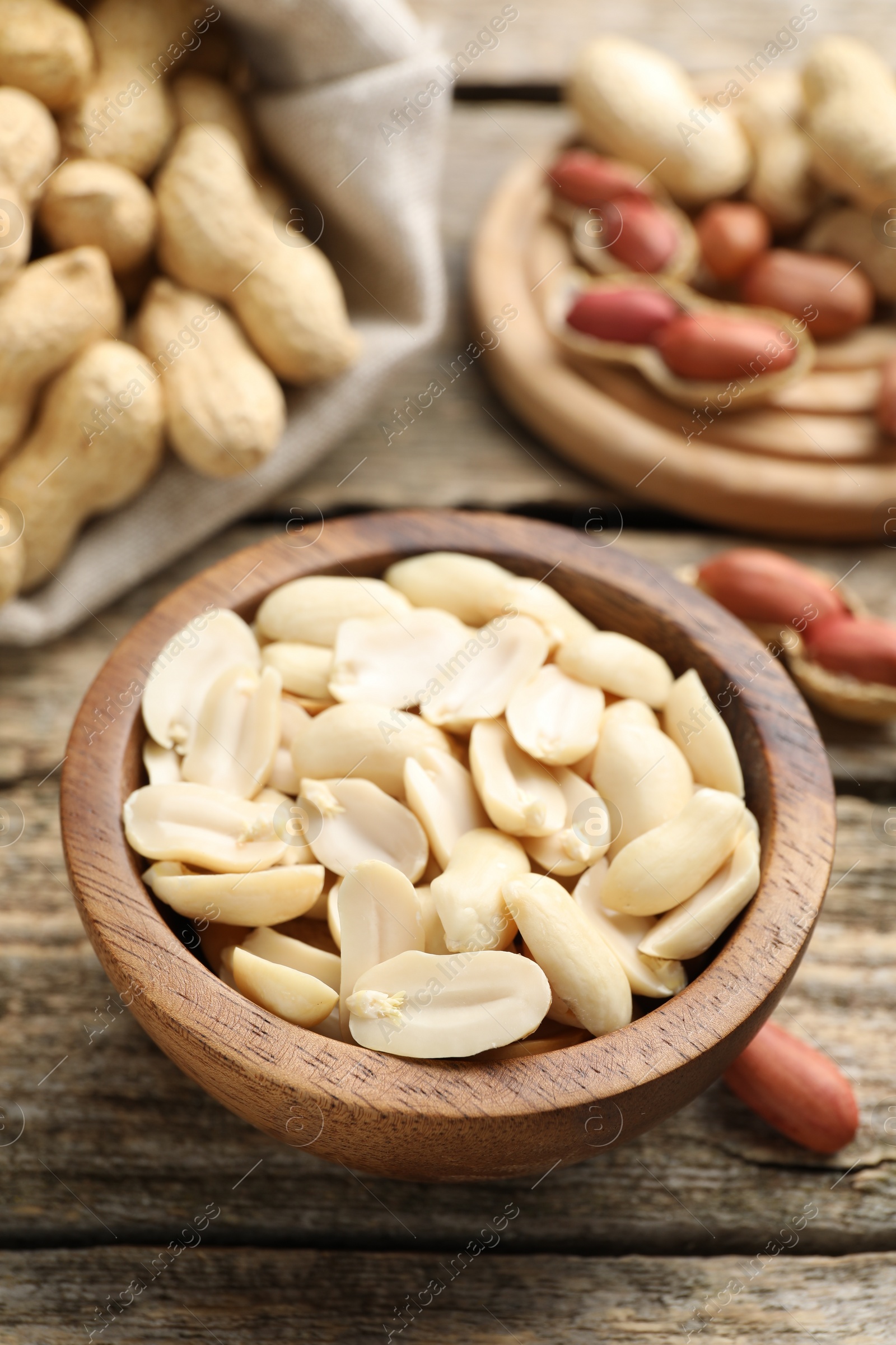 Photo of Fresh peanuts in bowl on wooden table