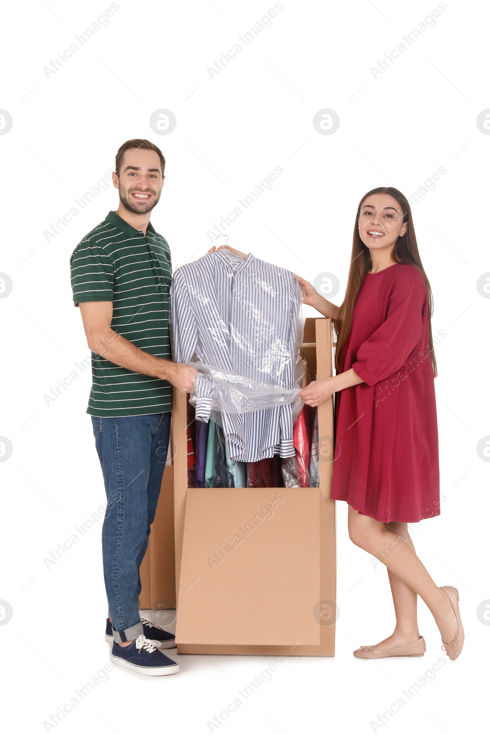 Photo of Young couple near wardrobe box on white background