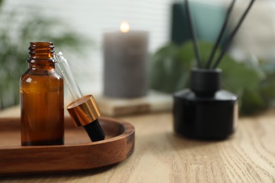 Photo of Aromatherapy. Bottle of essential oil on wooden table