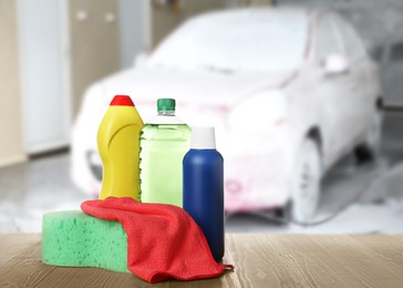 Image of Cleaning supplies on wooden surface at car wash. Space for text