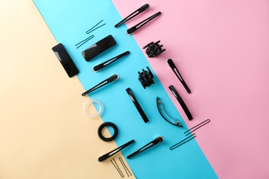 Photo of Flat lay composition with professional hairdresser tools on color background