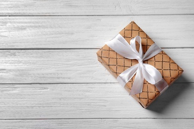 Photo of Beautiful gift box on wooden background, top view