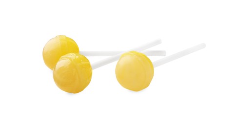 Photo of Many sweet yellow lollipops isolated on white