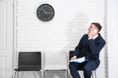 Photo of Young man waiting for job interview, indoors