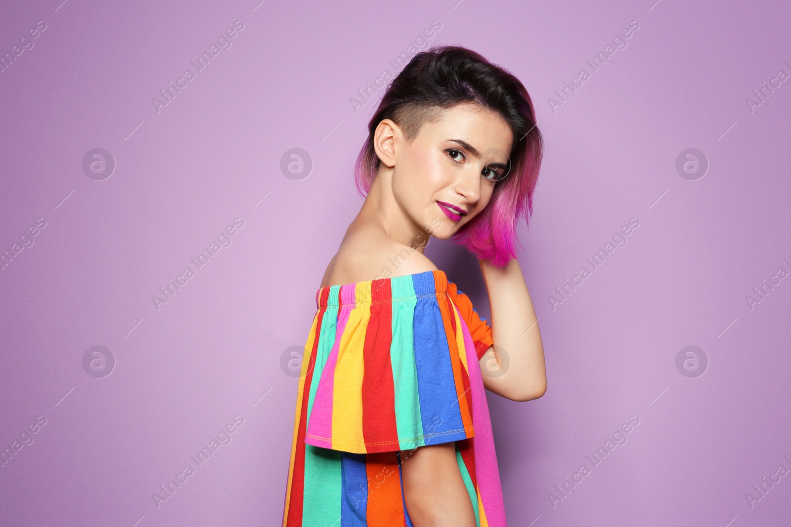 Photo of Young woman with trendy hairstyle against color background