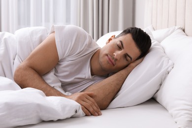 Photo of Handsome man sleeping in bed at home