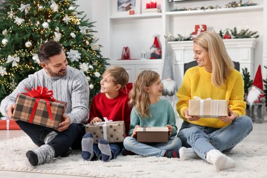 Photo of Happy family with Christmas gifts at home