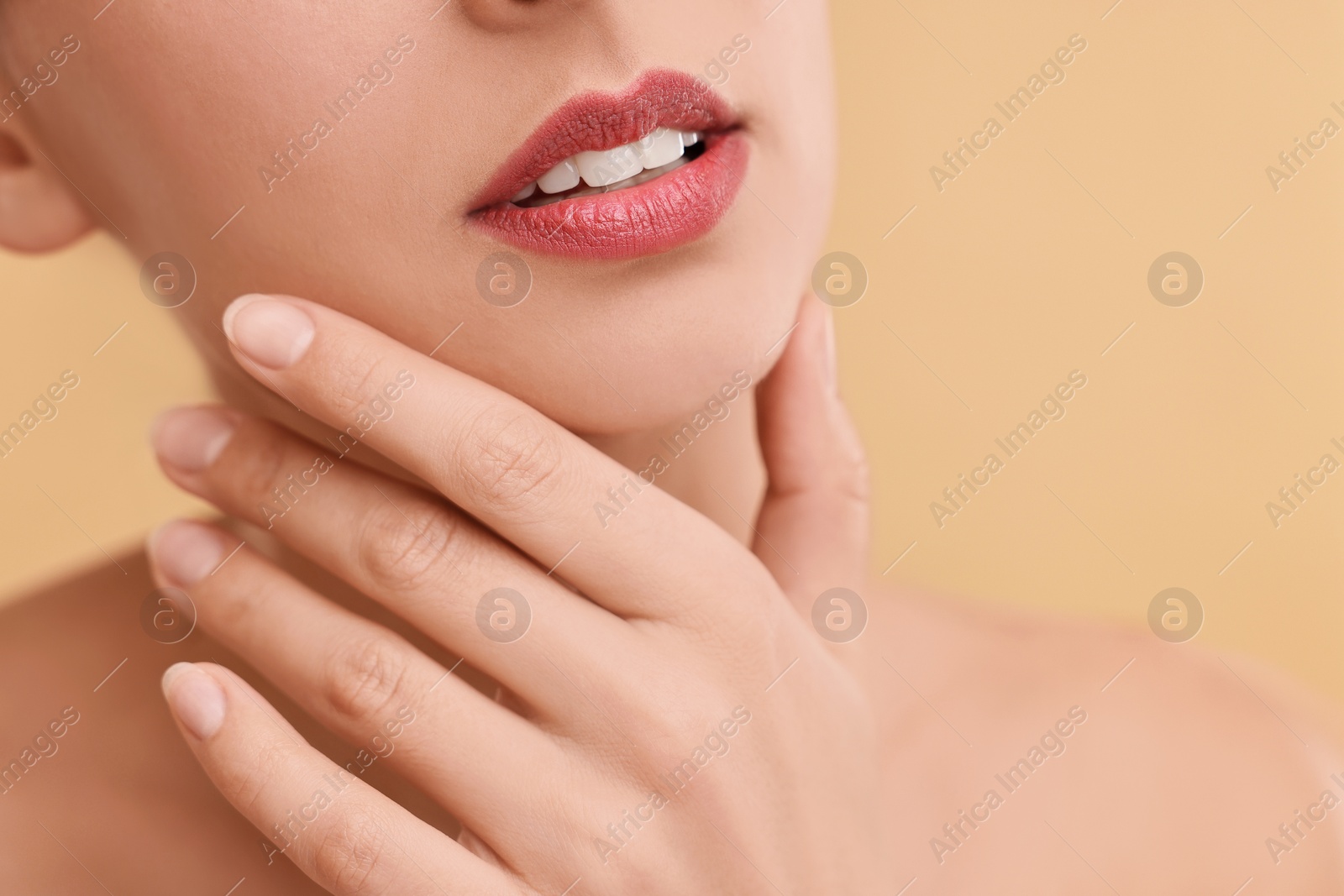 Photo of Woman with beautiful lips on beige background, closeup