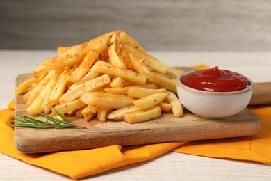Photo of Delicious french fries served with sauce on white wooden table, closeup