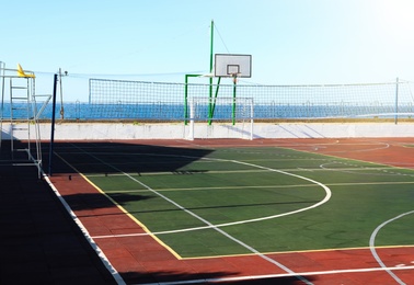 Photo of Empty multi-sport game court near sea on sunny day